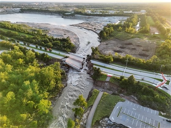 Aerial view of the washed-out Hazel Dell Parkway bridge and floodwaters reversing into the Carmel quarry, August 18, 2026